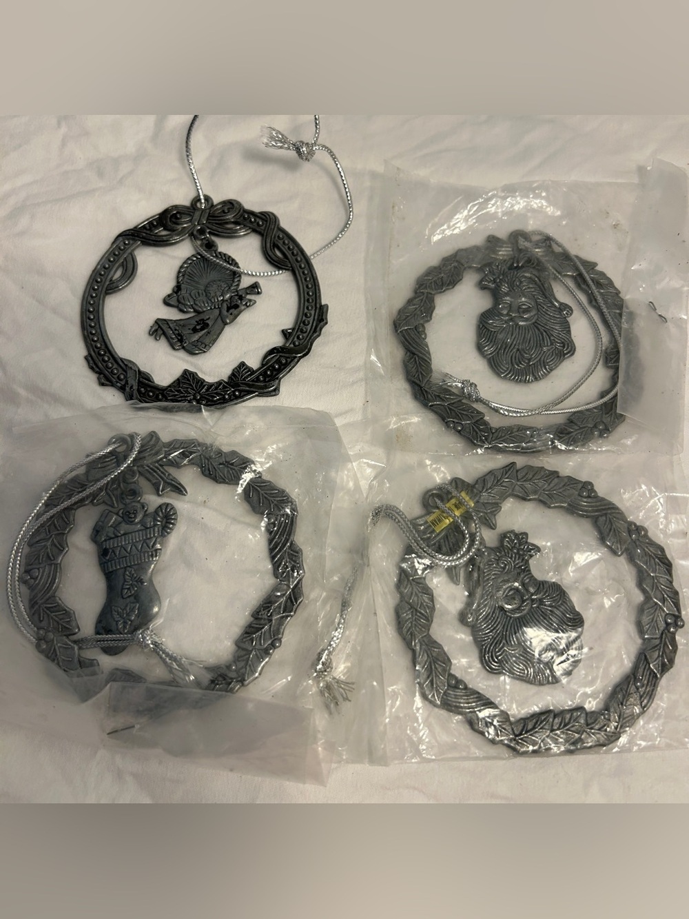 Set of Four Silver Tone Holiday Ornaments with Santa and Stocking Motifs